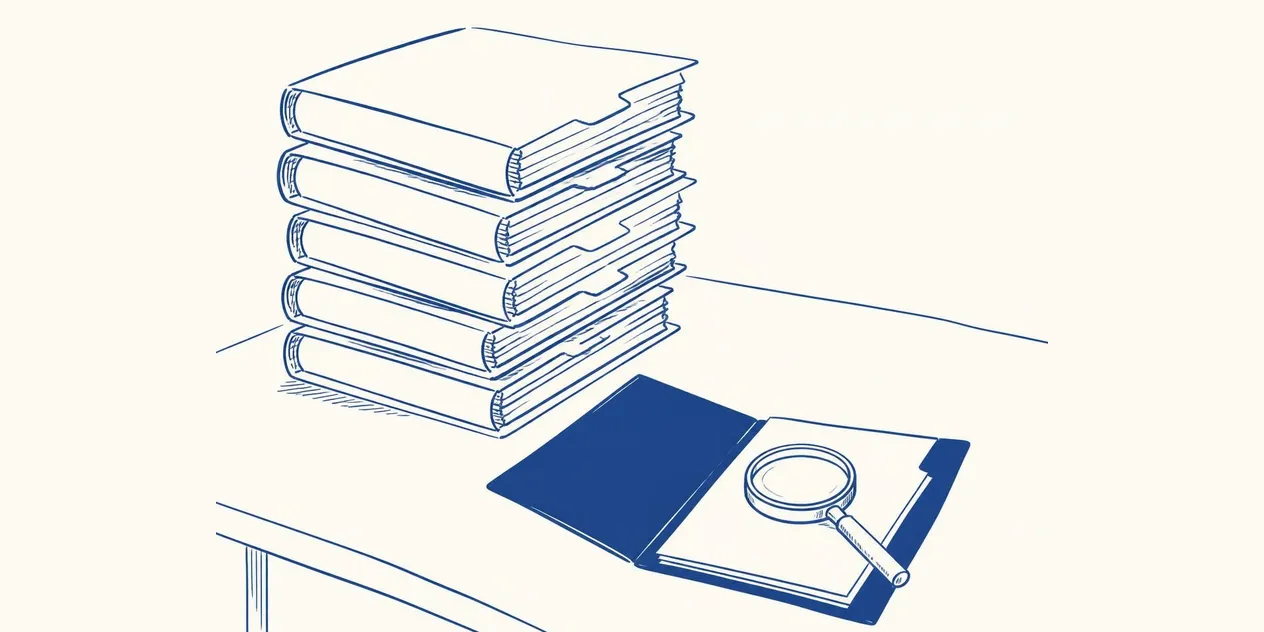 A stack of thick binders on a desk and, beside it, a thin open file under a magnifying glass.